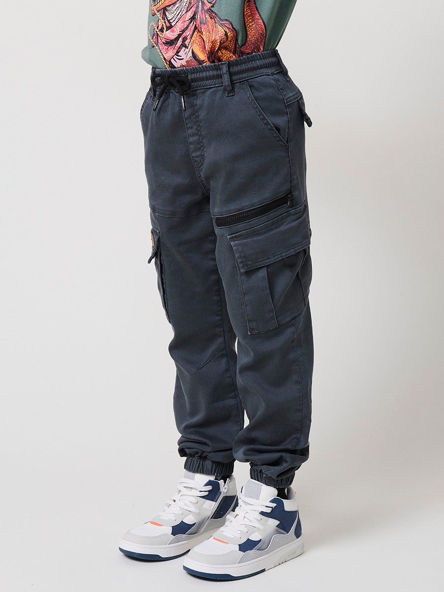 Pantalón jogger de niño en knit denim elástico color verde con bolsillos cargo. 100% algodón, cómodo y moderno.