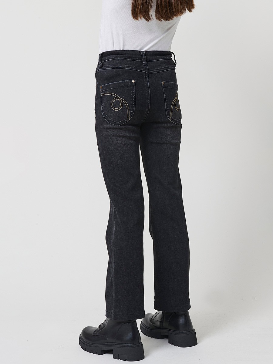 Pantalón de niña en denim elástico color black, pierna recta, cinco bolsillos y cinturilla regulable.